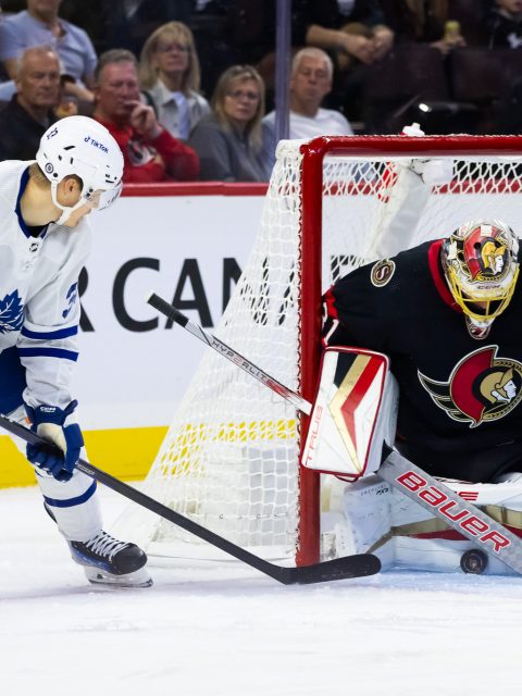 Ottawa Senators' Mark Kastelic (12) gets knocked off his skates after a  check by Toronto Maple Leafs' Sam Lafferty (28) during second period NHL  preseason hockey action in Ottawa, on Sunday, Sept.